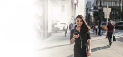 A happy woman using a mobile phone with a Canadian SIM